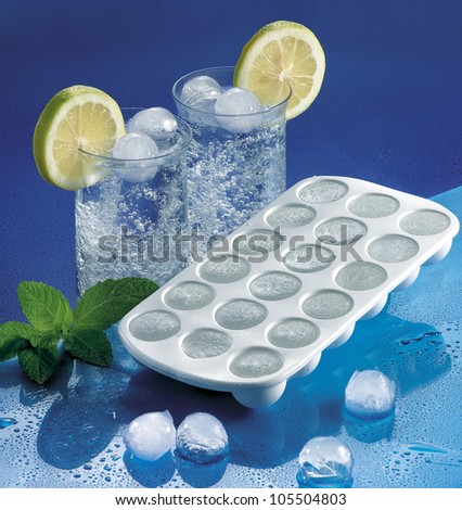 Plastic Ice cube tray and cold cocktails. Summer drink.