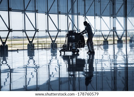 BARCELONA, SPAIN - CIRCA MAY 2010: Cleaning staff  at new Barcelona Terminal airport hall. Building architetcural detail designed by Richard Bofill architect.