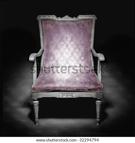 Old armchair in a dark ambiance