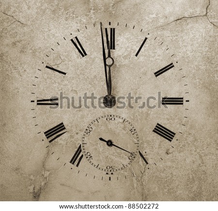 Clock face on a cracked stone. One minute to twelve.