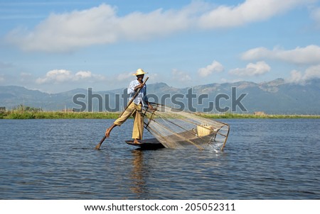 INLAY LAKE, MYANMAR - NOVEMBER 15: Inle lake water boatman (fishermen) with unique technique of leg-rowing on November 15, 2014 in Shan State, Myanmar (Burma).