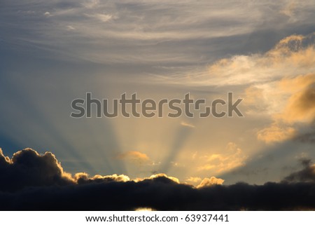 Sunbeam busts through clouds like a heavenly image of bright light