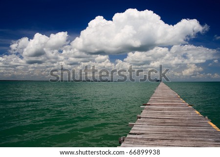 Ocean Pier with deep blue cloudy sky