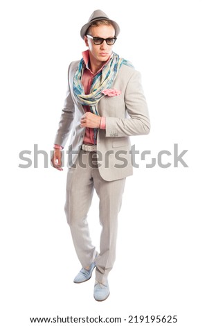 Elegant and fancy or funky fashion concept with blond male model wearing light grey suit, scarf, sunglasses and hat