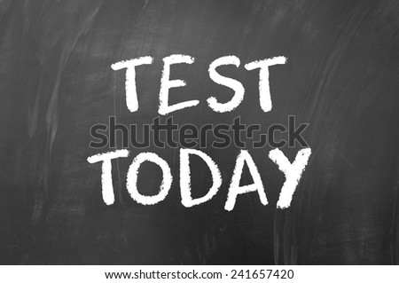 Test today written with white chalk on blackboard
