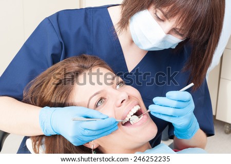 Oral exam on perfect teeth of a female patient sitting in the dentist chair