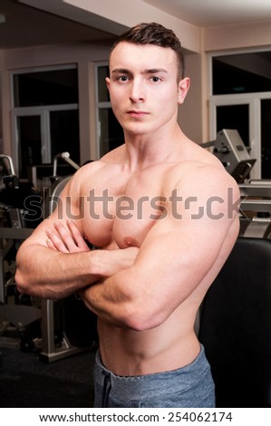 Confident body builder crossing his strong arms