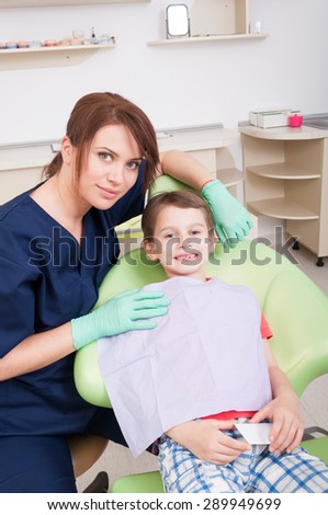 Kid patient smiling in dental office. No fear of dentist concept