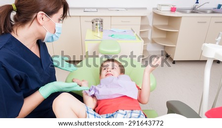 No fear of dentist concept with relaxed kid or child and friendly woman doctor