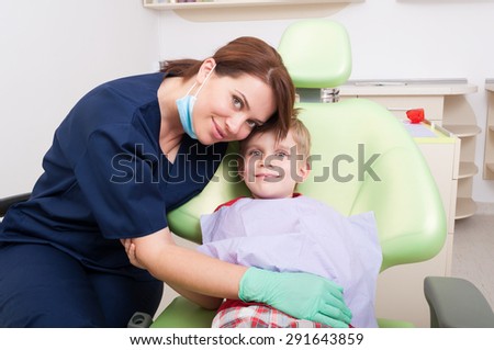 Friendly woman dentist concept with happy and relaxed kid or child patient