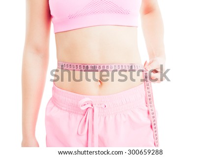 Woman measuring waist using a meter tape or ruler. Slimming with diet concept