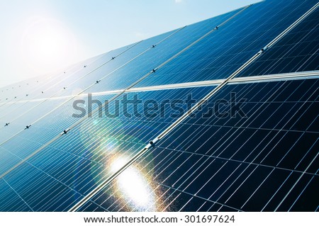 Sunray reflecting on solar power photovoltaic panel as green and renewable electric energy solution concept