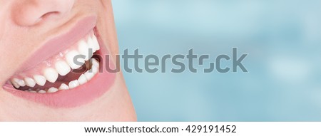 Closeup of perfect healthy smile of young woman as dental whitening concept with advertising area