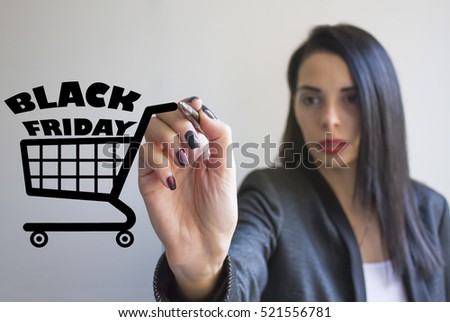 Young businesswoman writing black friday and drawing shopping cart