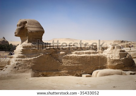 The Great Sphinx of Giza is a statue of a reclining lion with a human head that stands on the Giza Plateau on the west bank of the Nile, near Cairo in Egypt