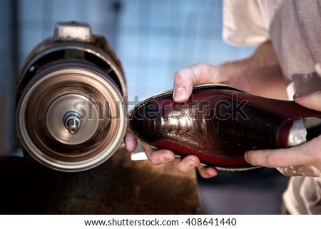 shoemaker makes shoes for men\
He polishes sole of shoe
