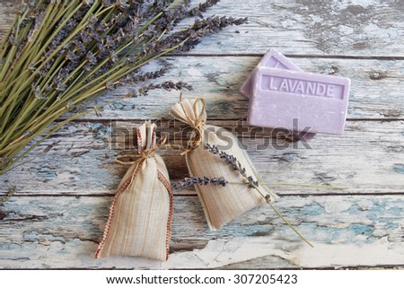 dried lavender and lavender soap  on rustic wooden board