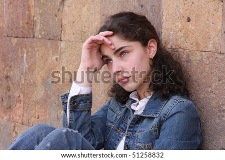 stock photo thinking teenager girl on wall background2