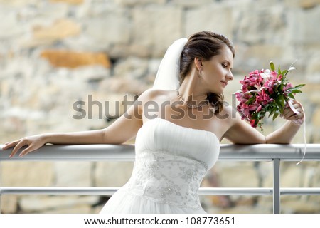 horizontal wedding portrait beautifull  fiancee with  bouquet  in white dress, soft light