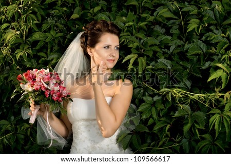 horizontal wedding portrait beautifull  fiancee in white dress with wedding veil, on nature
