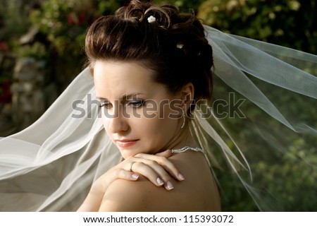 horizontal wedding portrait beautiful  fiancee in white dress with wedding veil, on nature