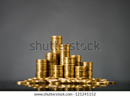 still life of very many rouleau gold  monetary or change coin, on grey background