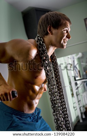 very power athletic guy  bodybuilder,  execute exercise on parallel bars, in sport hall