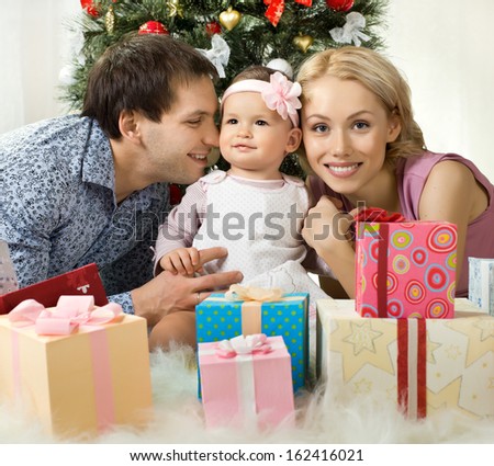 portrait very happy family in home with Christmas-tree and gift, smile