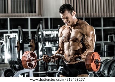 guy bodybuilder , execute exercise with weight in gym, horizontal photo
