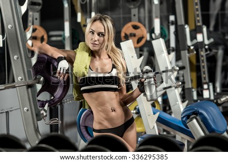young fitness woman tired in gym hold shaker with sportive nutrition - protein of shaker , horizontal photo