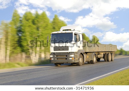 The empty lorry quickly rushes on highway, on a background of the beautiful nature