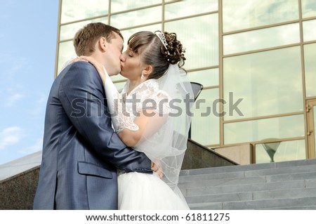 cutie happy married  couple  embrace  on architecture background and  hot kiss
