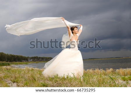 the beauty happy married  couple  stand on coast, puff wind, imminent  storm-cloud