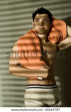 slender  sexy man,  wipe wet hair bath-towel, vertical photo, smile