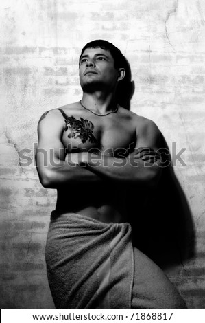 slender muscular beauty sexy man with  bath-towel, vertical photo, black and white color