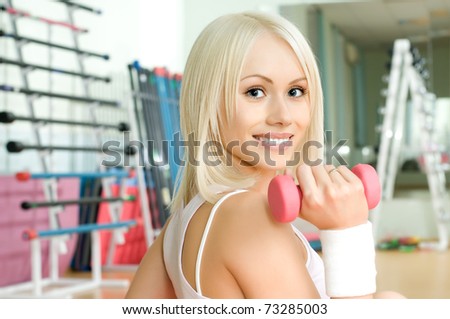 happy cutie athletic girl ,  execute exercise  with pink dumbbells and smile,  close up face