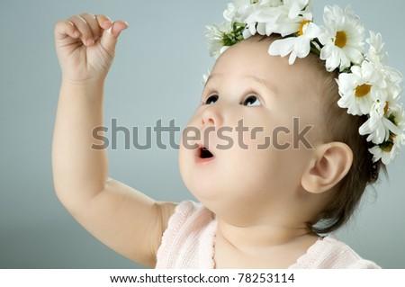 very beautiful  little kid with diadem of flowers, stare , very closeup face