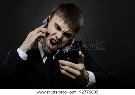 closeup portrait  the  beautiful  businessman careerist in black costume,  call and angry cry