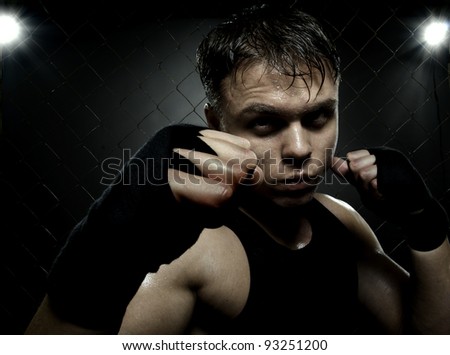 horizontal photo  muscular young  guy street-fighter,  aggression look, hard light