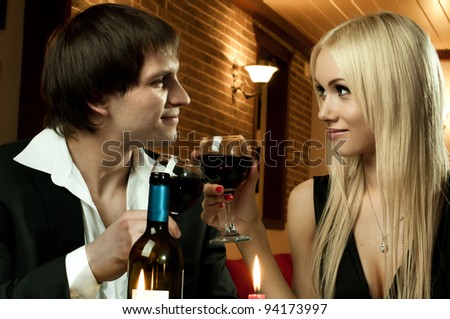 romantic evening date in hotel room, or supper in restaurant, happy couple with wine glass