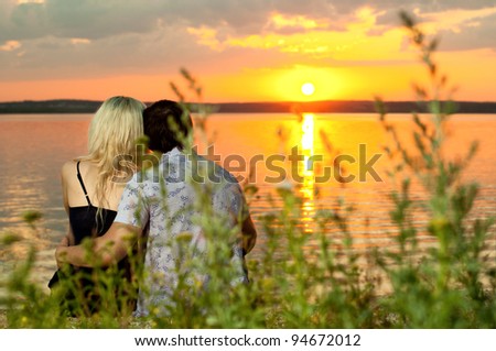 horizontal photo the  happy  couple, outdoor on beauty sunset or sunrise, on beach