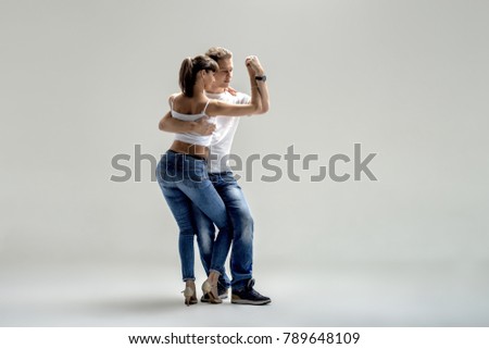 beauty couple dancing social danse ( kizomba or bachata or semba or taraxia) , on light grey background