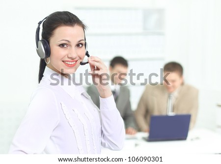 Beautiful business woman operator in the office with his team.