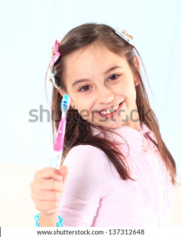 The little girl brushing her teeth.