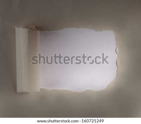Brown package paper torn to reveal white panel ideal for copy space