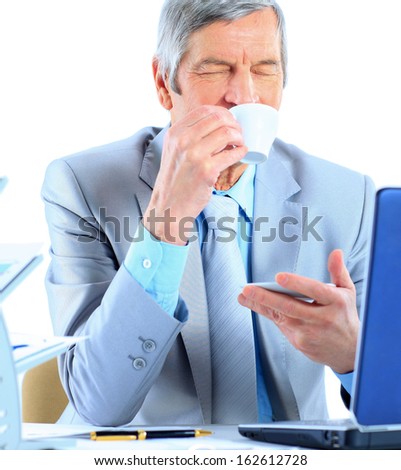 The businessman at the age of drinking coffee during the break. Isolated on a white background.