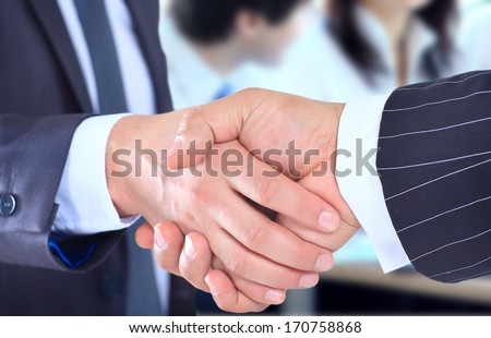 The conclusion of the transaction. Handshake.