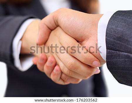 High angle view of business woman and man shaking hands