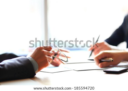 Banking business or financial analytics desktop with accounting charts, pen and glasses