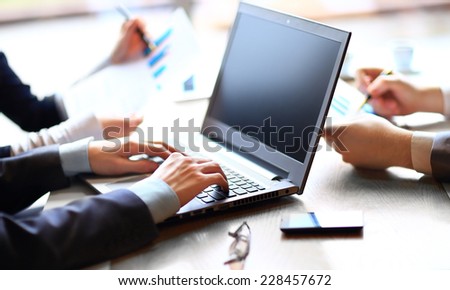 business and office concept - close up of business team with files and laptop computer in office